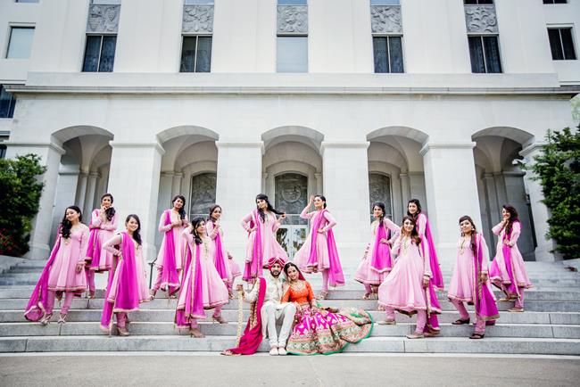 Sikh Punjabi bride and groom with bridesmaids in pink suits