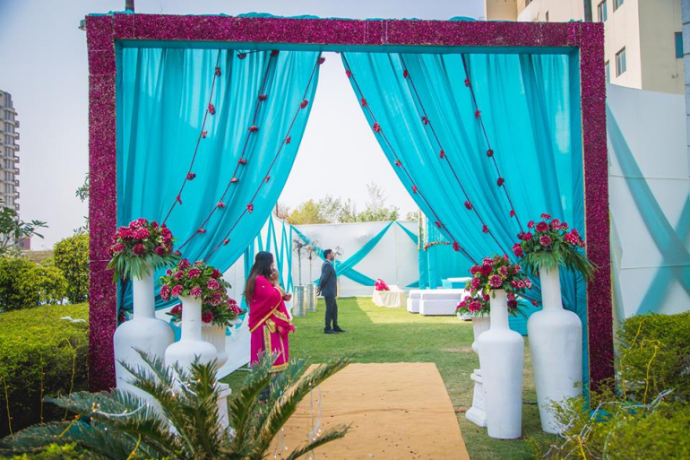 fabric entrance with big pots - the girl in pink