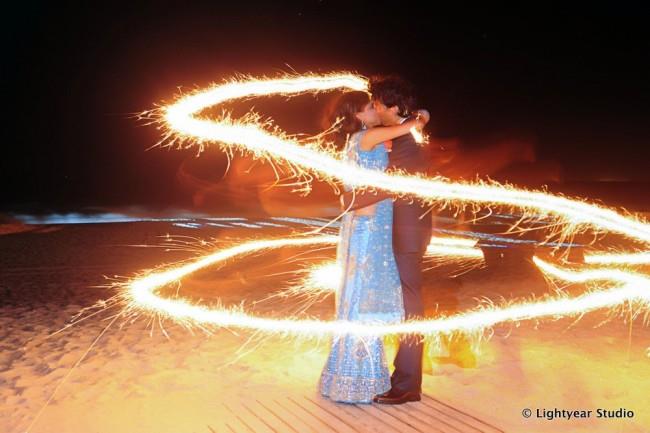 couple kissing with fireworks 