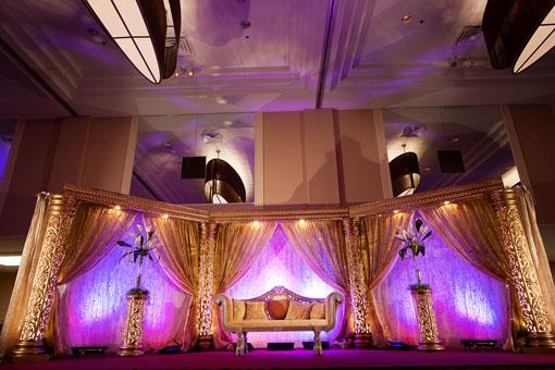 _MG_8738_Stage with gold pillars and draping and gold sofa with purple uplighting