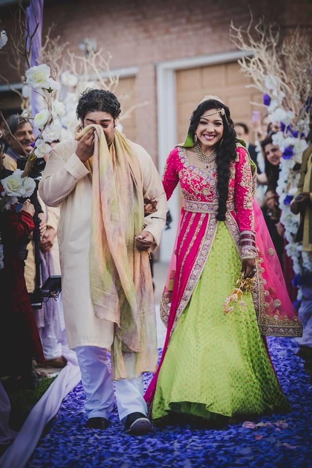 indian wedding bride walking down the aisle bridal lengha